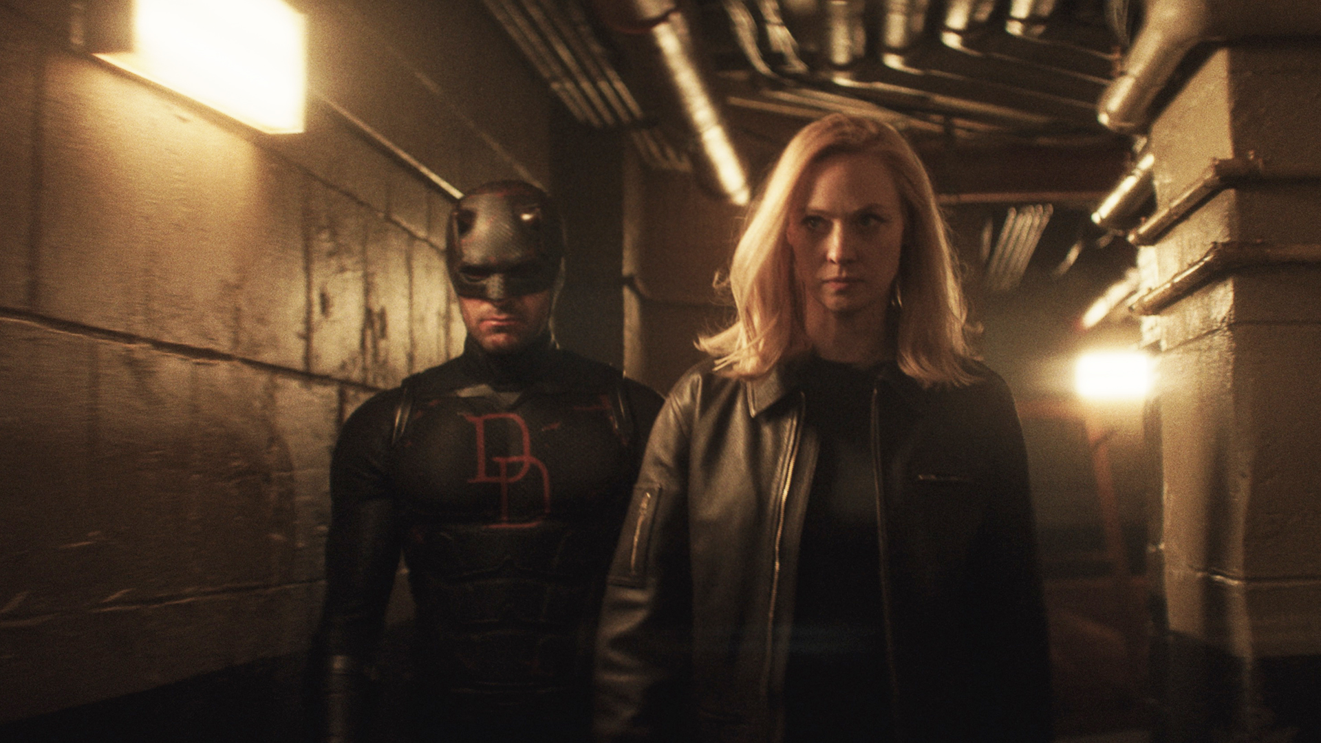 Matt Murdock and Karen Page walking down a dimly lit corridor in Daredevil: Born Again season 2