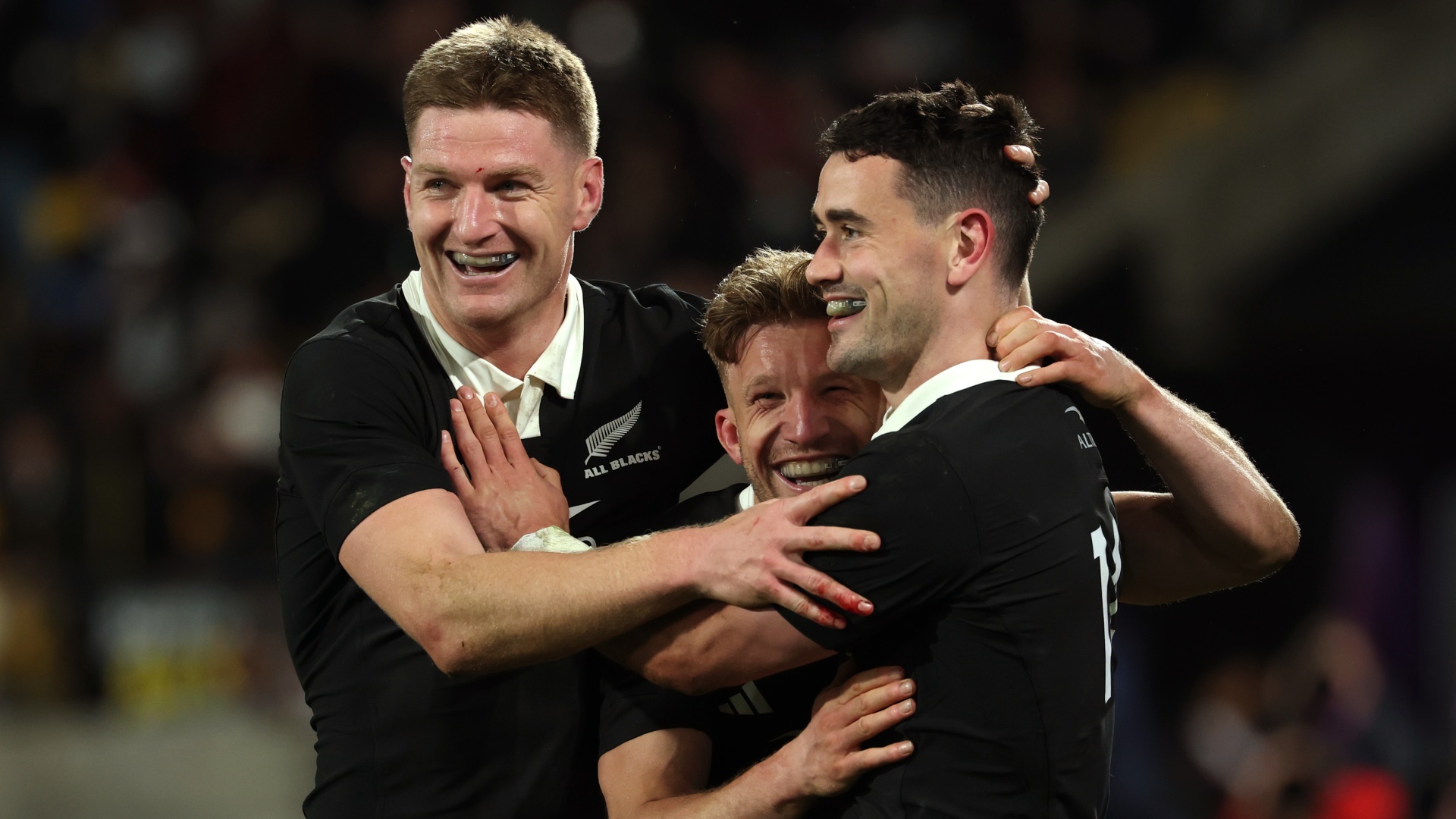 All Blacks Will Jordan, Damian McKenzie and Jordie Barrett celebrating at Nations Championship 2026
