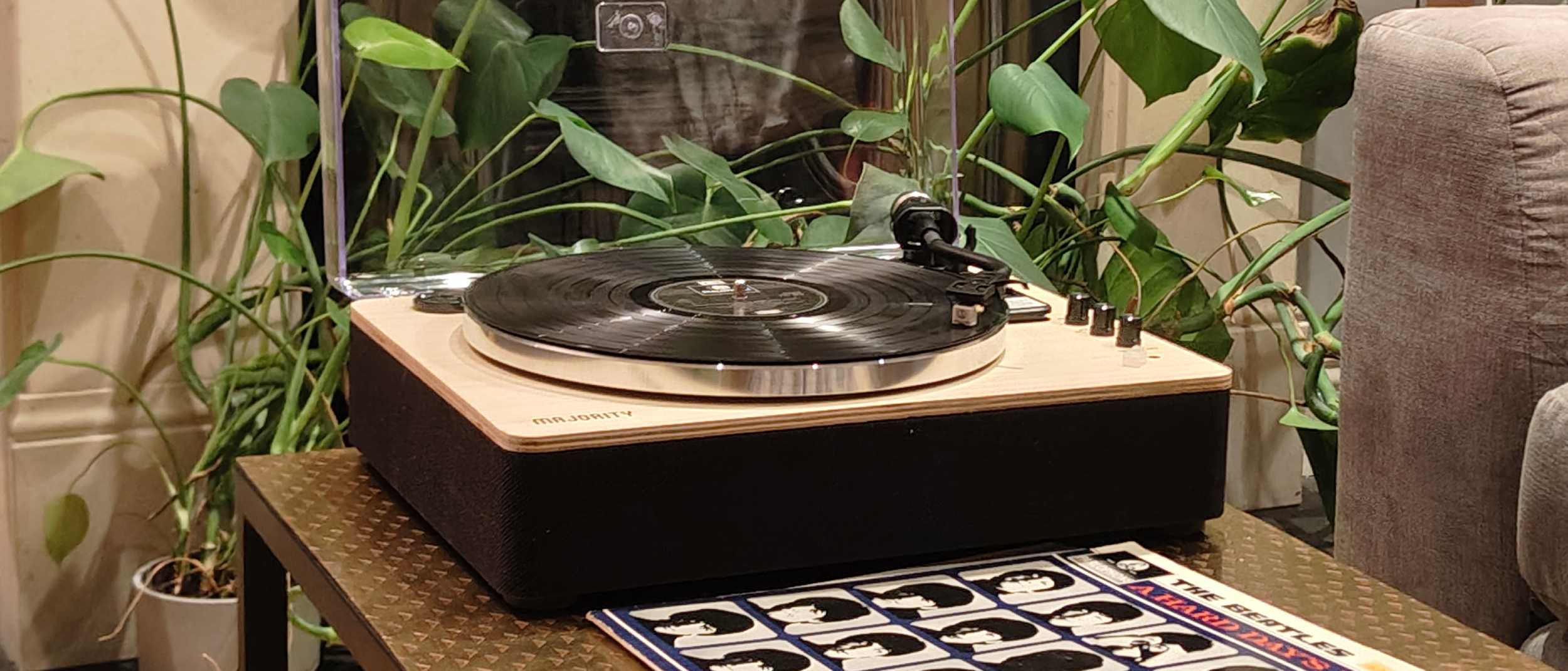 The Majority Folio on a bronze table with plants in the background.