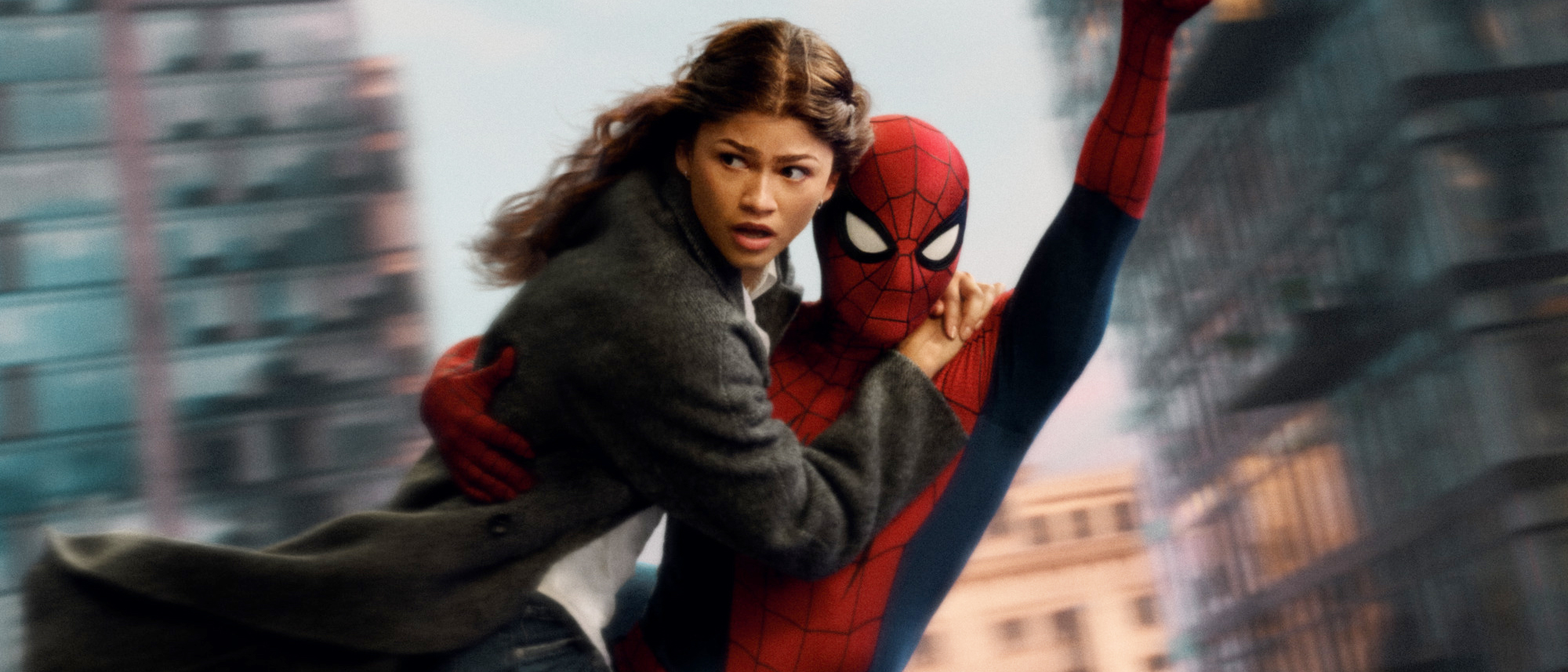 M.J looking scared as she clings to Spider-Man as they swing through New York City in Spider-Man: Brand New Day