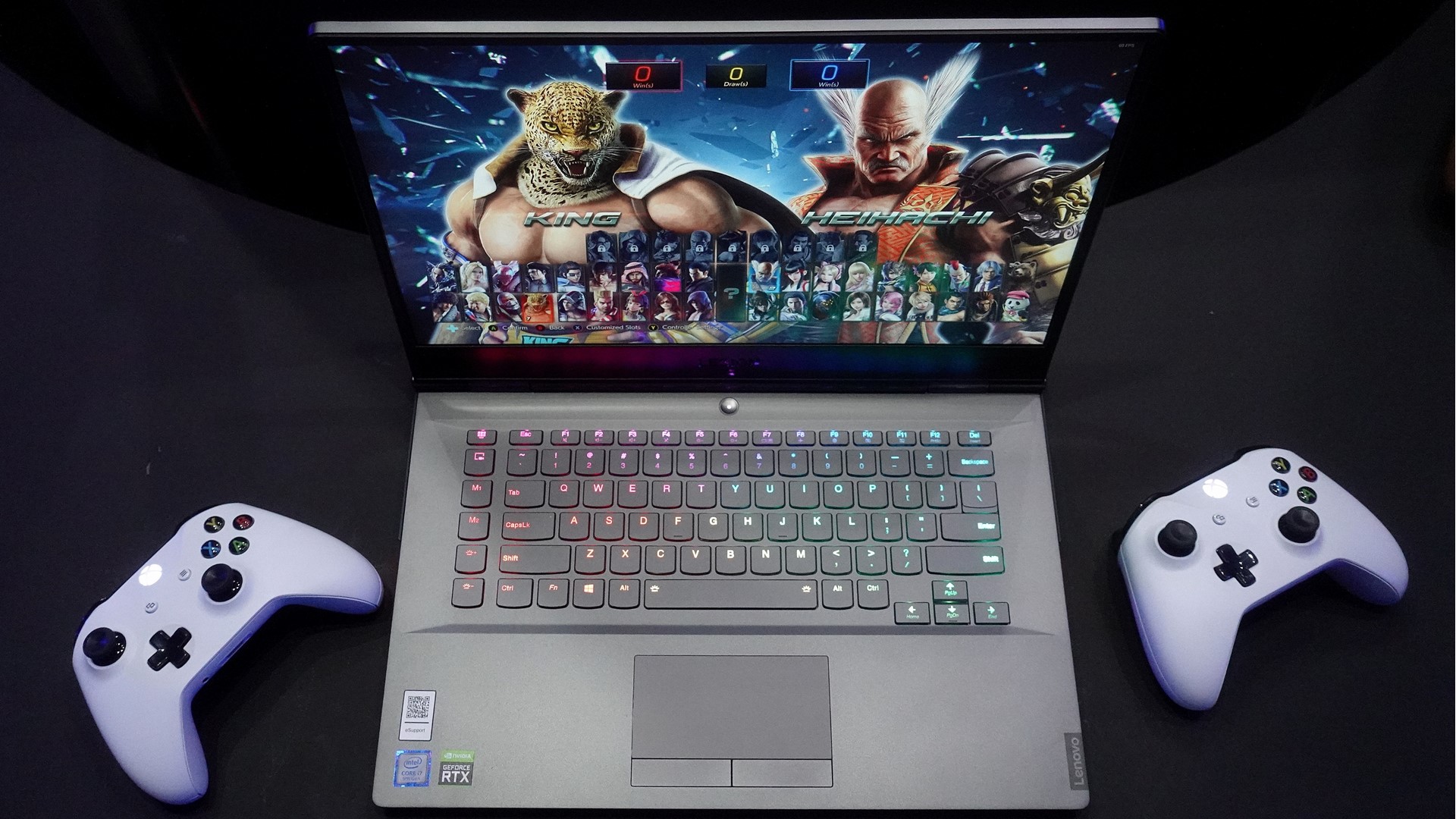A Lenovo Legion gaming laptop with two gaming controllers