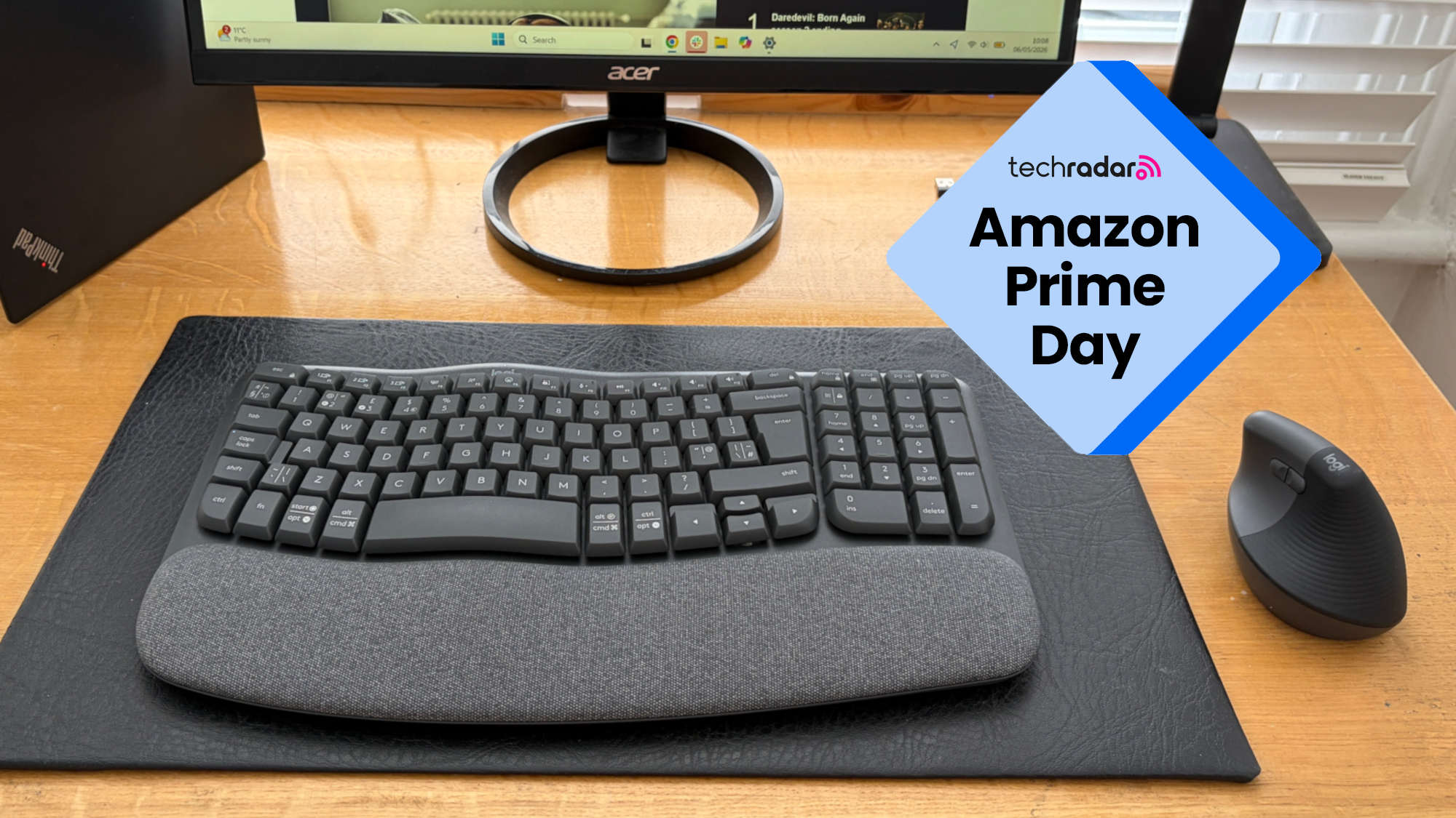 The Logitech Wave Keys and Logitech Lift on a wooden desk