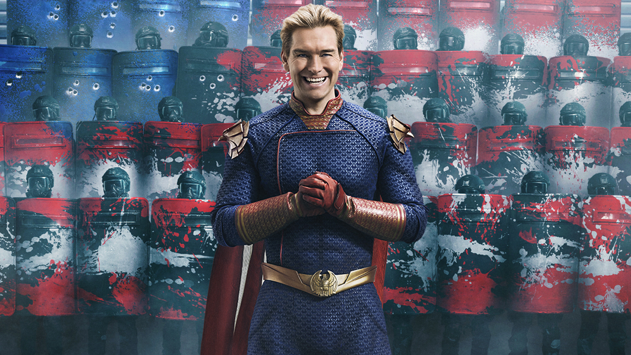 Homelander smiles as he clasps his hands in front of some armed US soldiers in The Boys season 4