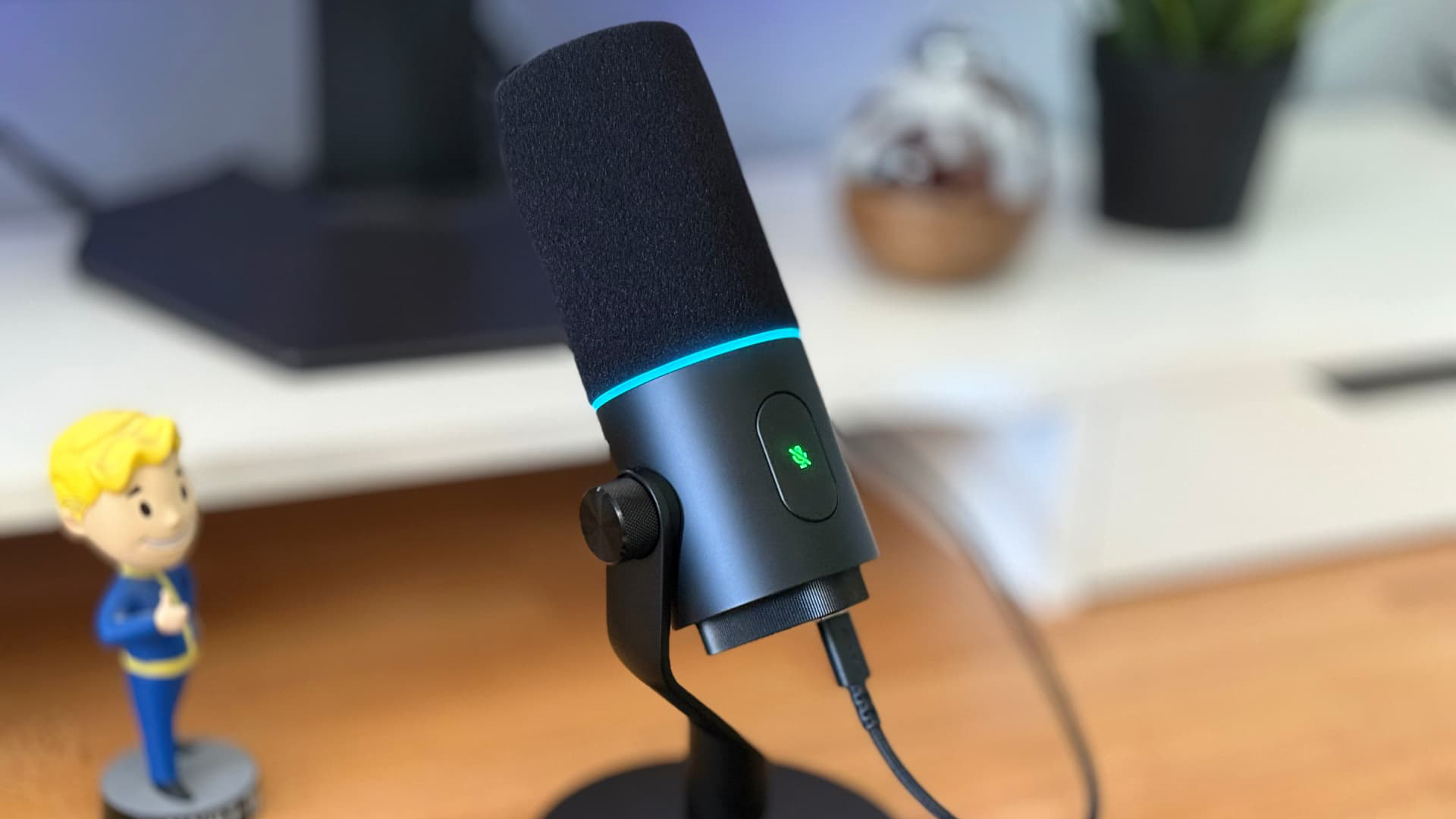 Razer Seiren V3 Pro microphone on wooden desk