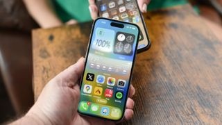 Two iPhones starting a new AirDrop sharing session on iOS 17 showing wavy animation on screen