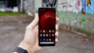 A Sony Xperia 5 III held in someone's hand against a wall