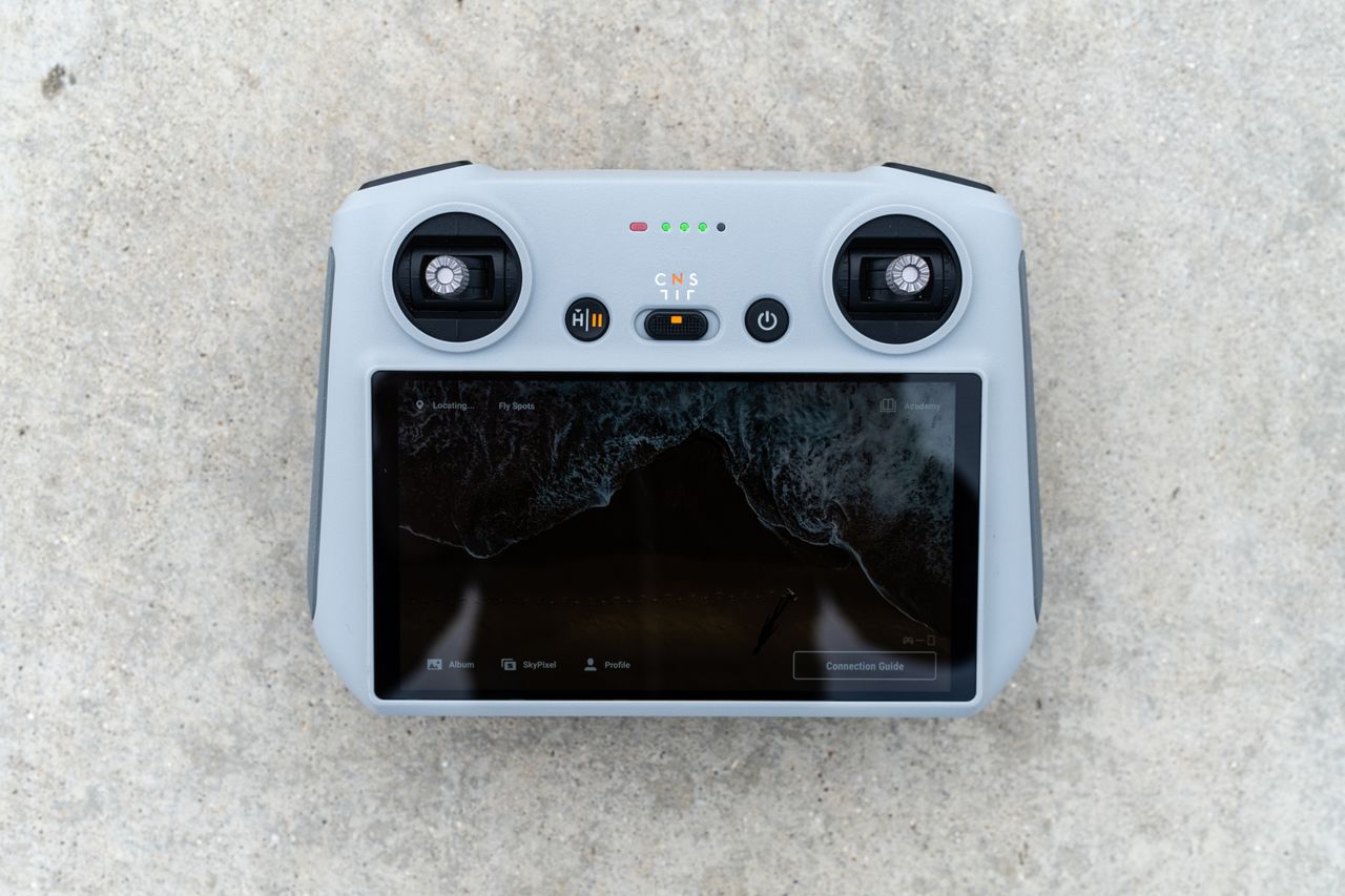 The DJI Mini 3 Pro drone resting on the ground