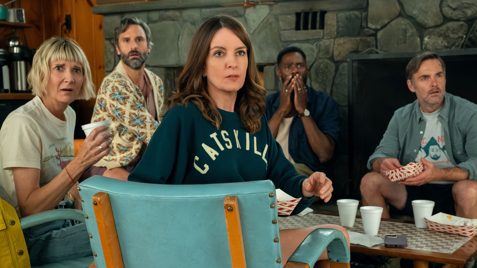 The cast of The Four Seasons look shocked at something across the room