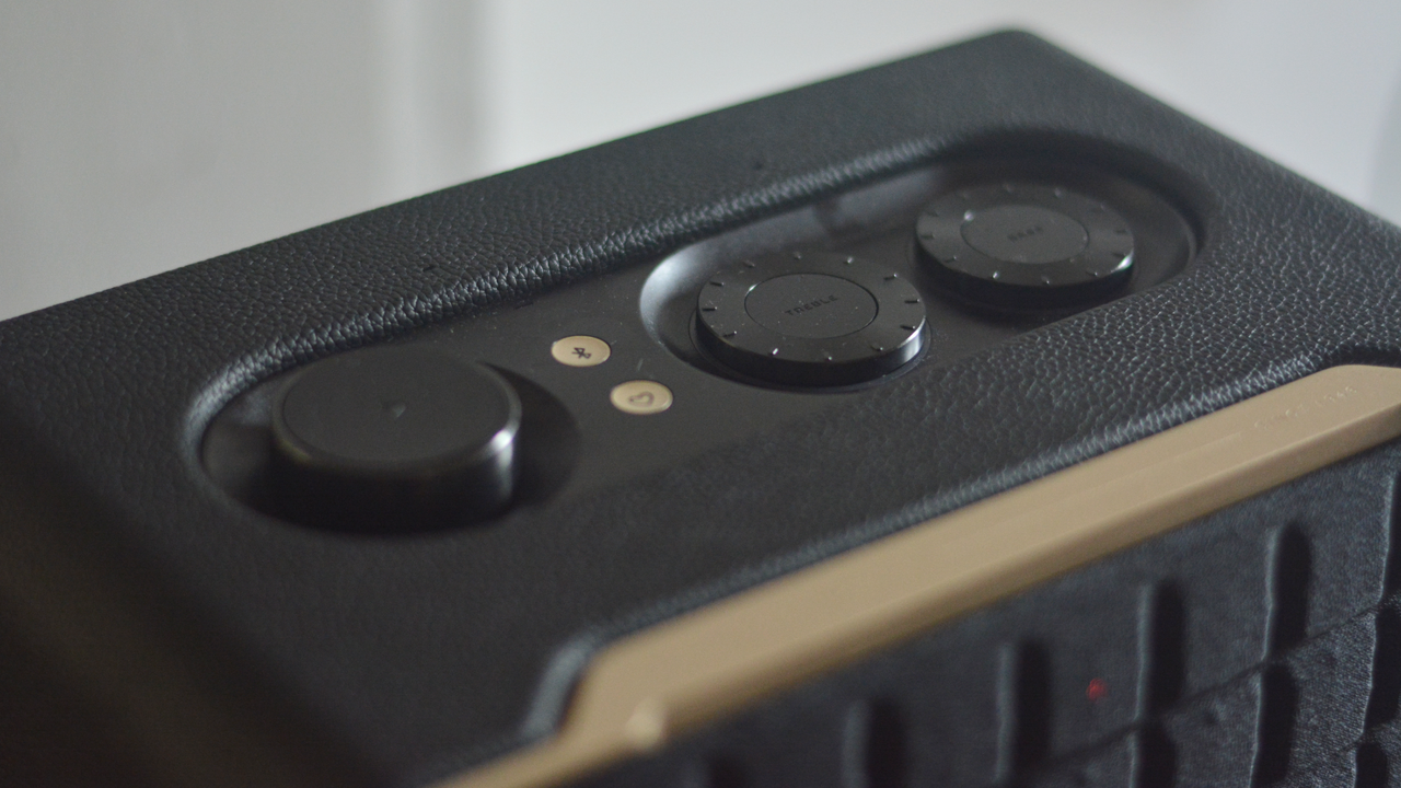 The JBL Authentics 200 speaker's three control dials, and two other control buttons, on its top. They sit inside a slightly recessed space.