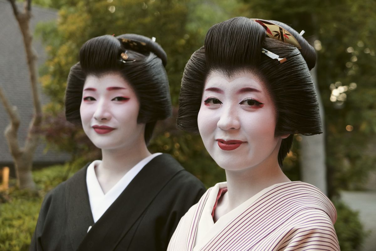 Sample image taken with the Panasonic Lumix L10; two ladies in a traditional Japan ware in attractive garden with pond