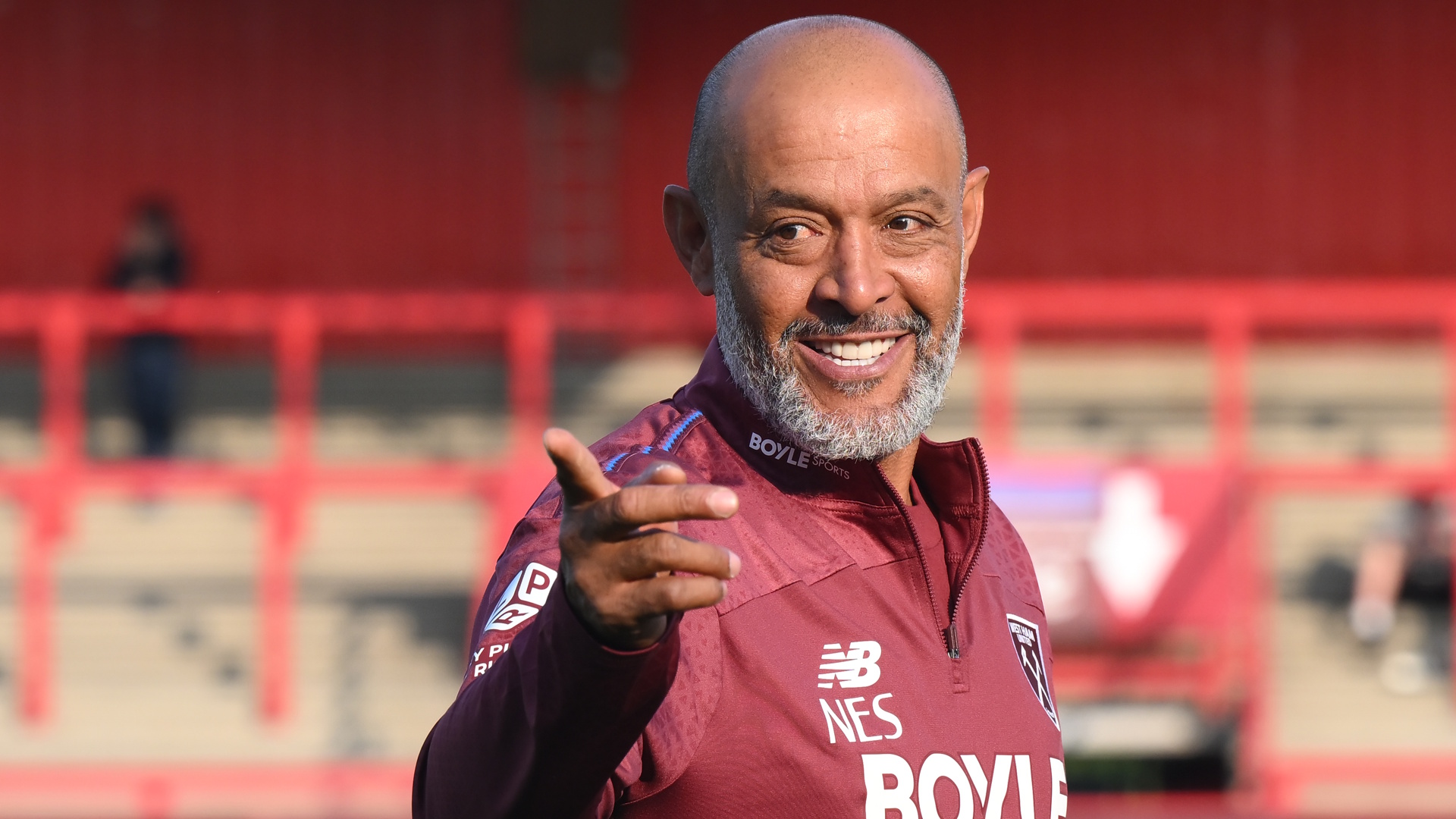 Nuno Espirito Santo, head coach of West Ham United, smiles and points.