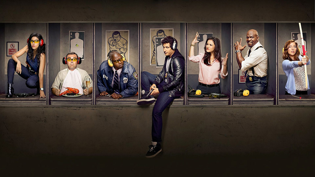 Brooklyn Nine-Nine cast doing different poses behind a screen.