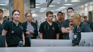 The cast of The Pitt look at something off screen