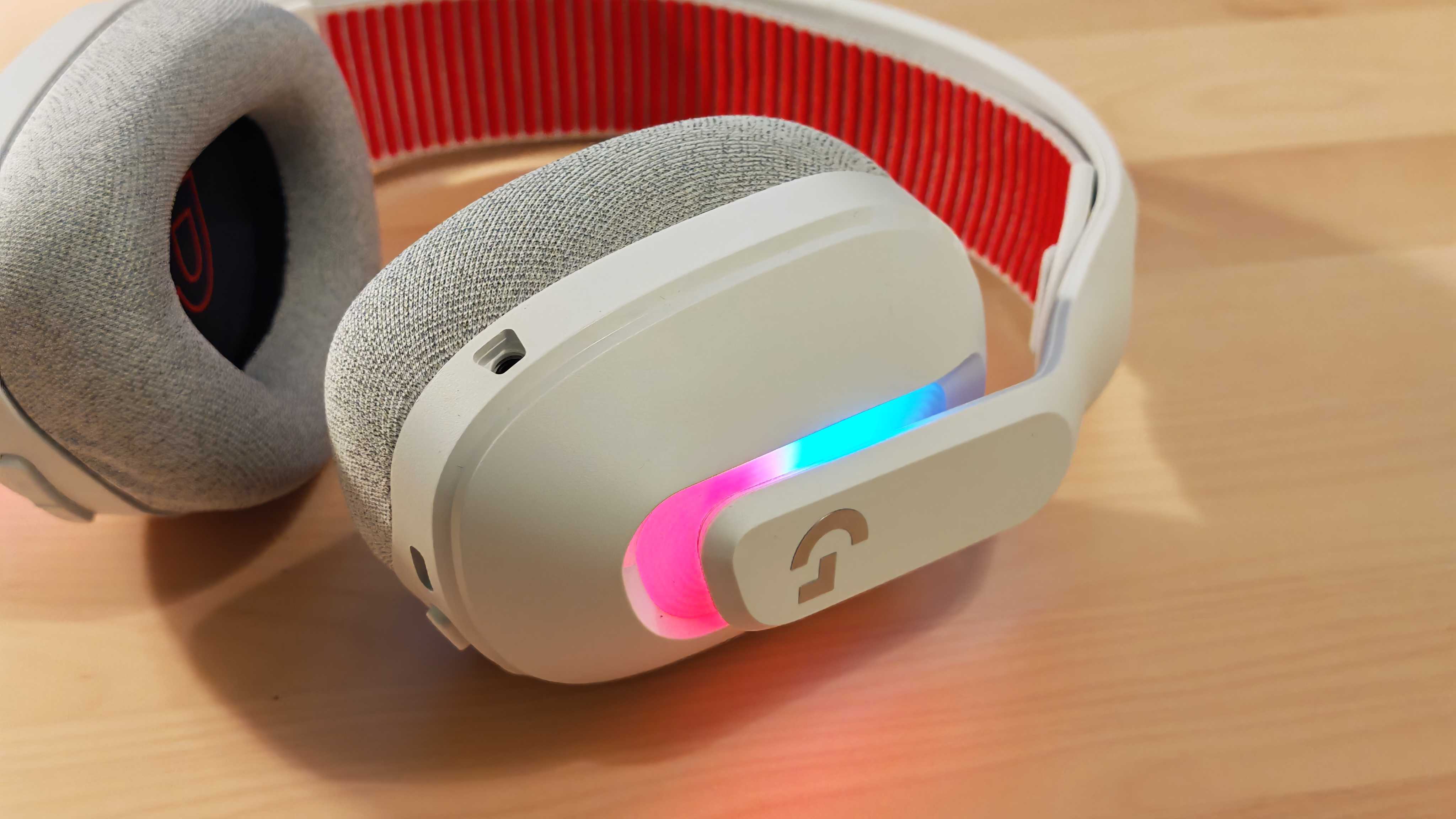 The Astro A20 X gaming headset on a wooden desktop surface.