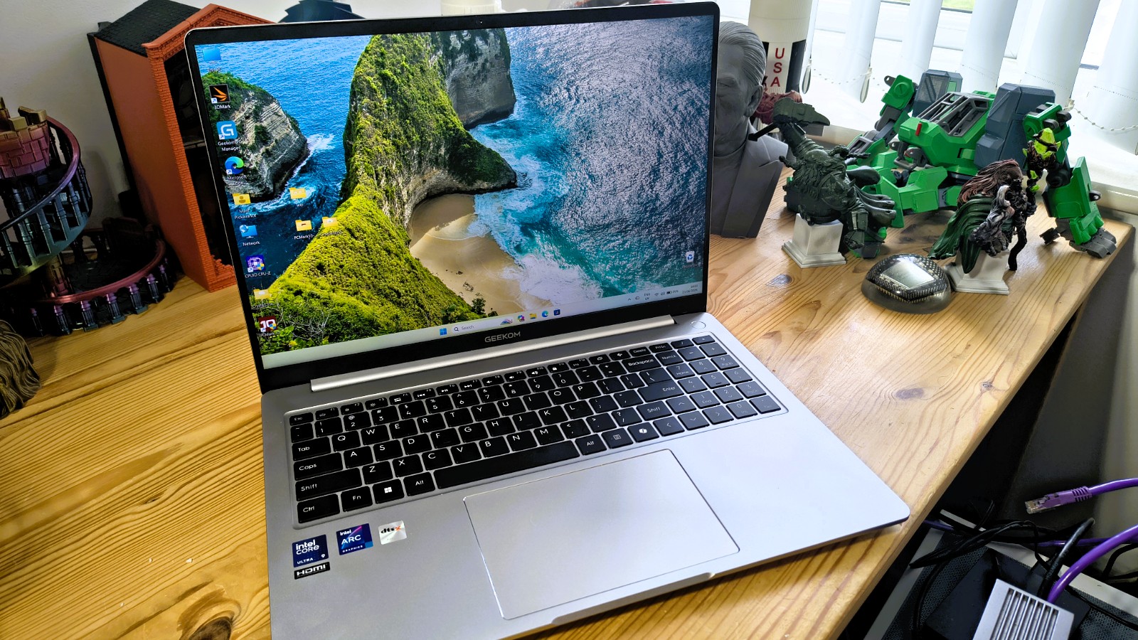 Geekom GeekBook M16 on a desk in a home office during our review