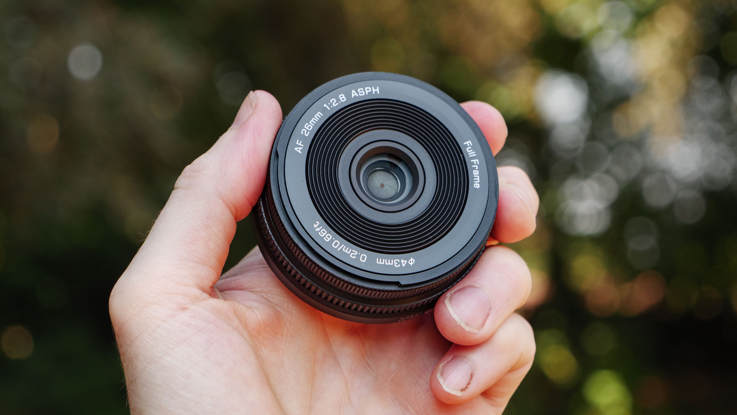 Viltrox AF 26mm F2.8 EVO 'pancake' lens in TechRadar's Cameras Editor Tim Coleman's hand