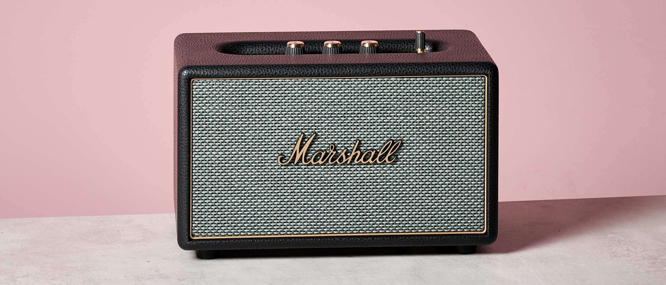 Marshall Acton IV on table against pink background
