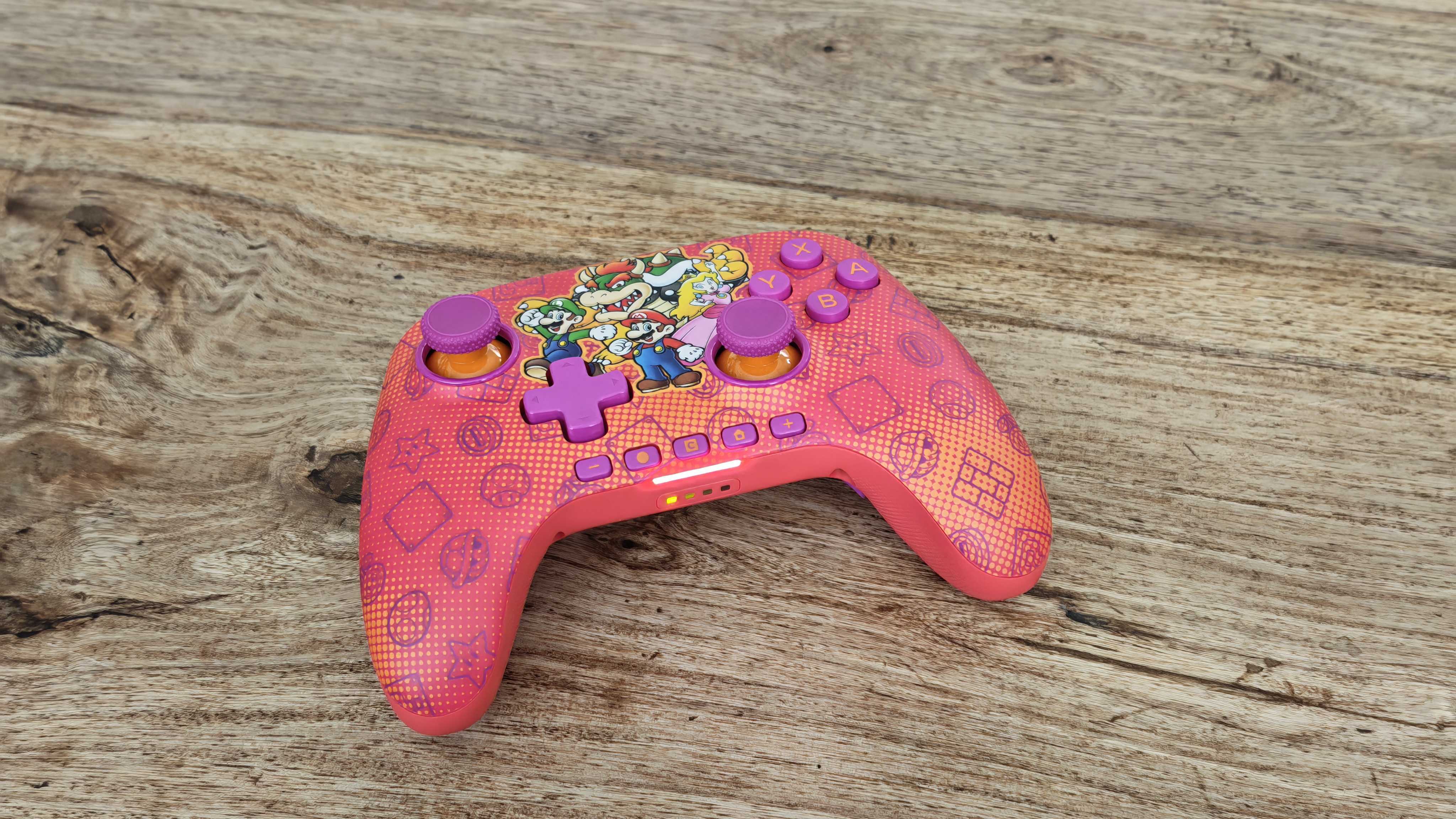 The PowerA Advantage Wireless Controller for Nintendo Switch 2 on a wooden table surface.
