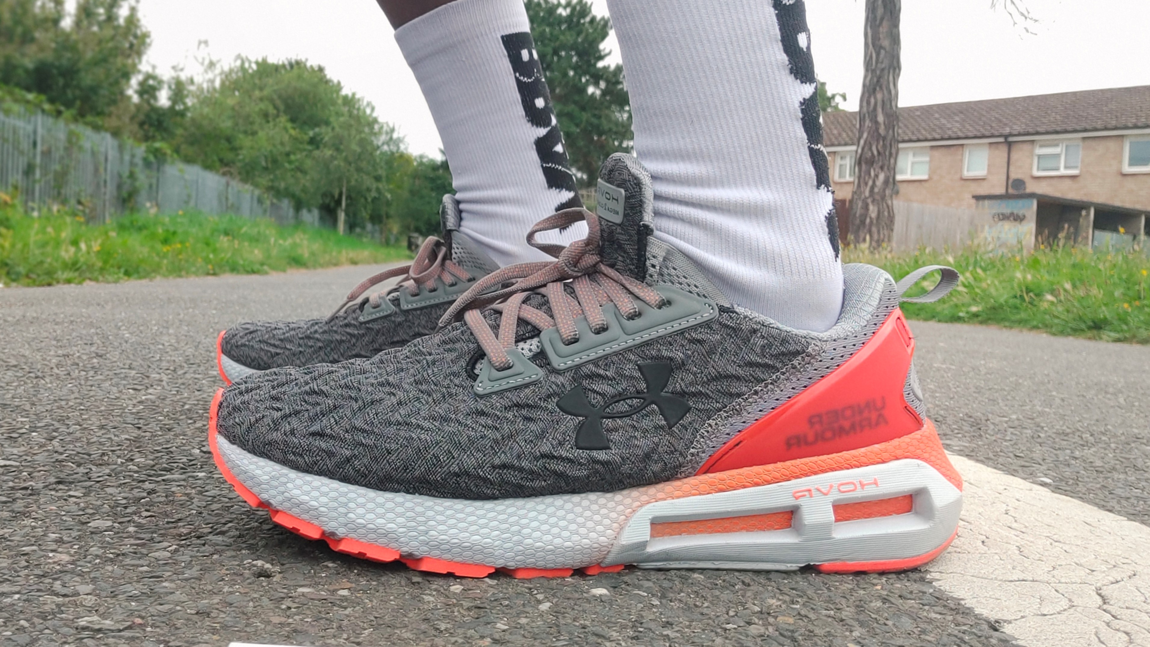 Man's feet wearing Under Armour HOVR Mega 2 Clone