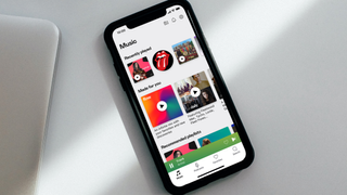 A promo image of the Deezer app open on a smartphone
