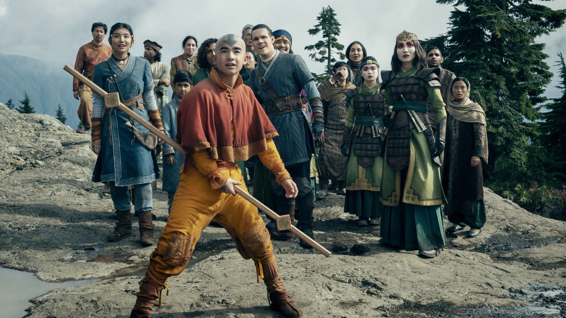 Aang protects a group of people standing on a rock