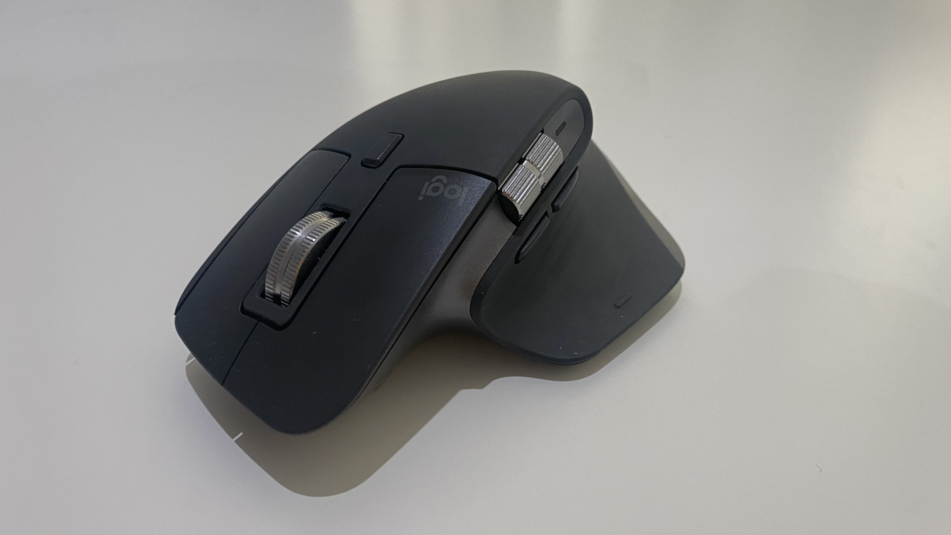 The Logitech MX Master 3S wireless mouse on a white table