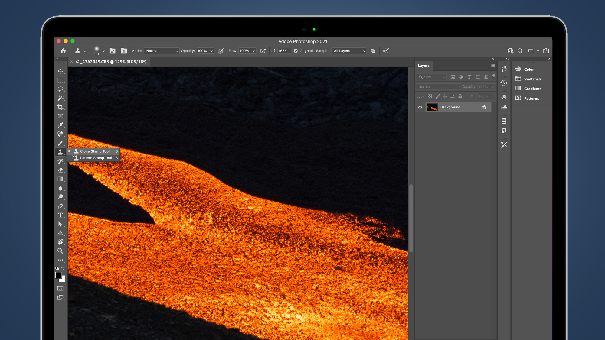 Laptop screen showing Photoshop's clone stamp tool