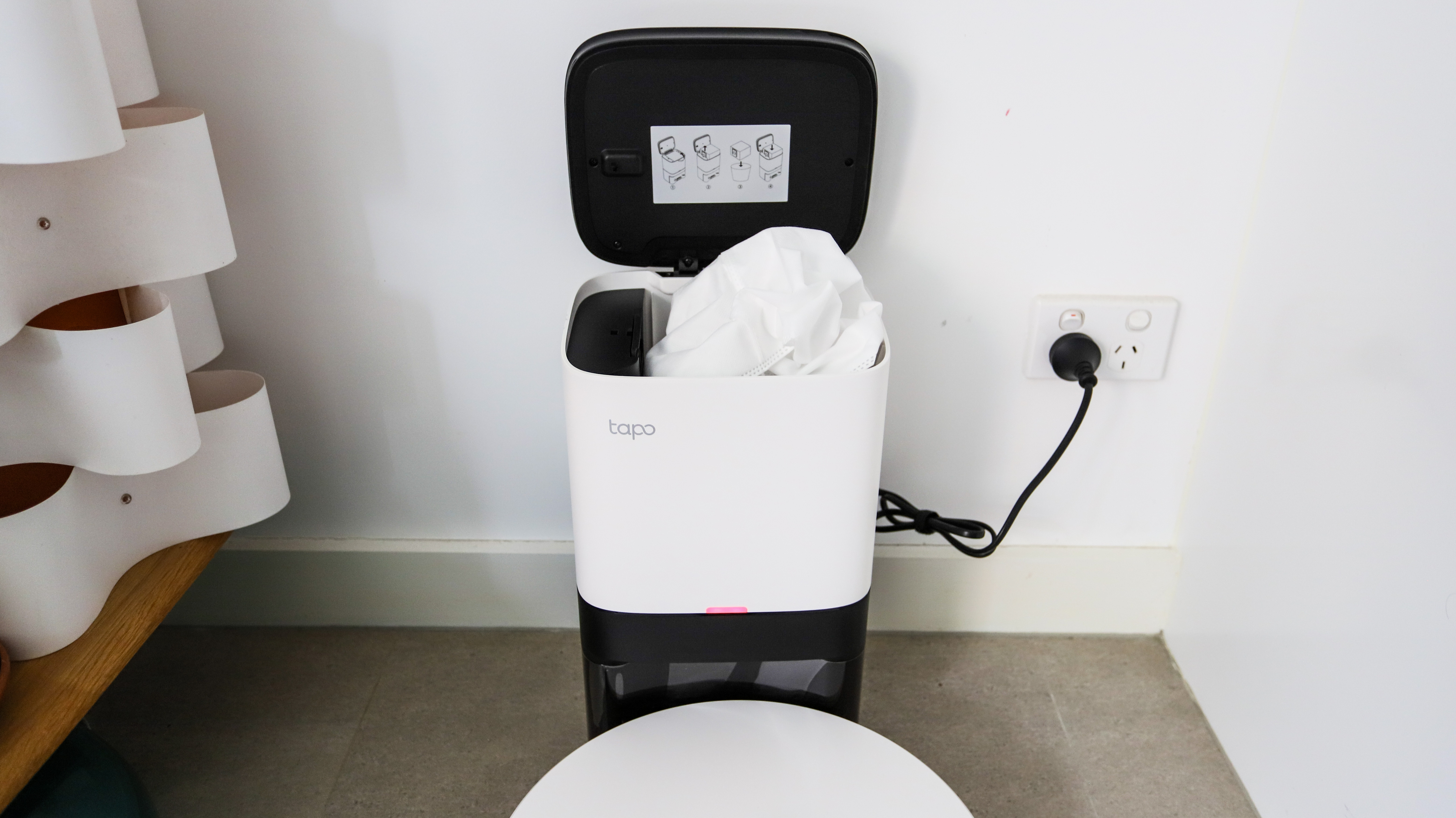 The auto-empty dock open to reveal the dust bag of the TP-Link Tapo RV30 Plus