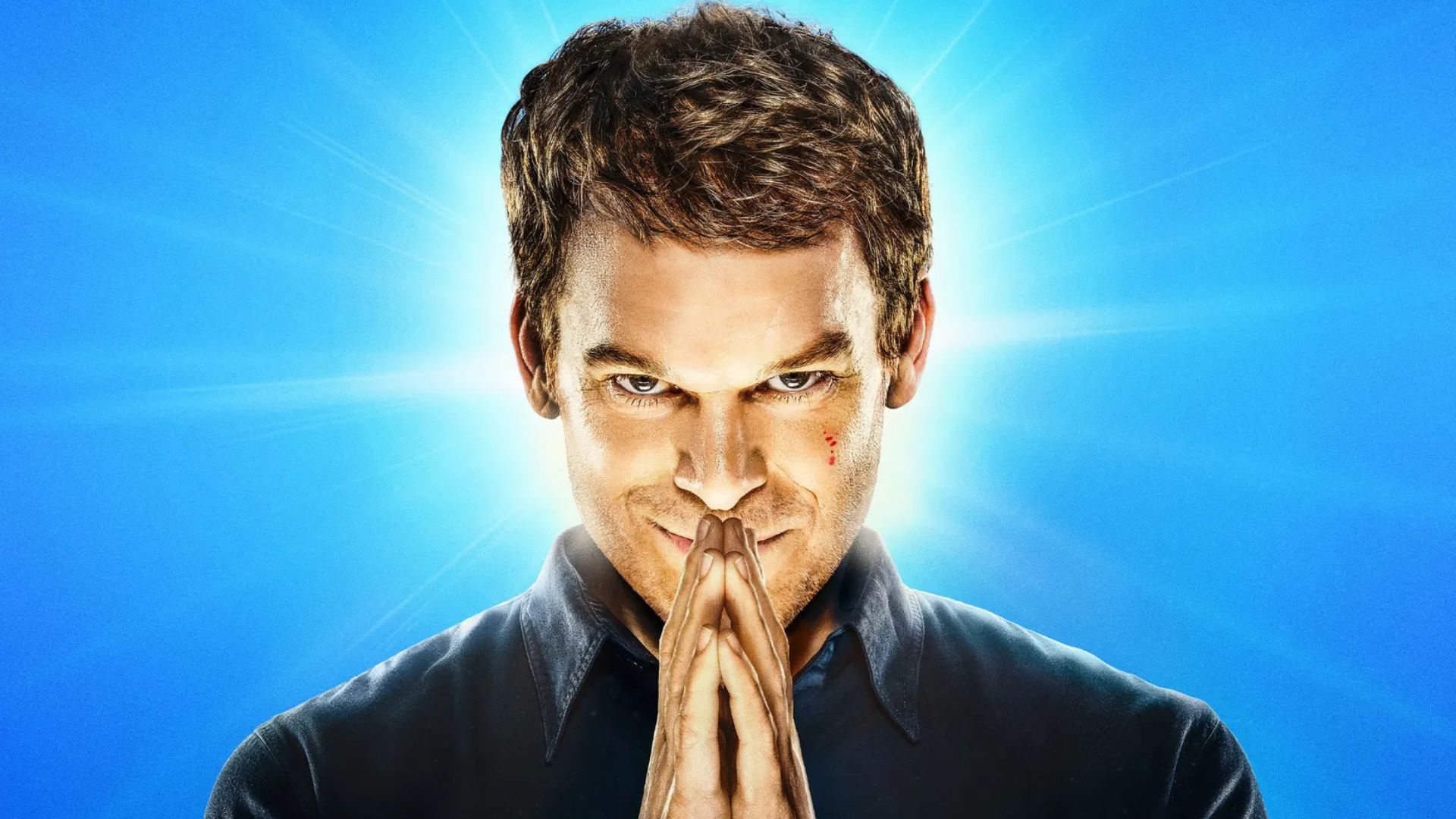 Dexter puts his hands together in a prayer position in front of his face
