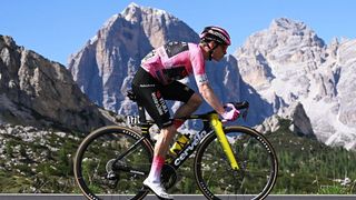 Jonas Vingegaard rides in front of the Dolomite mountains during the Giro d'Italia 2026