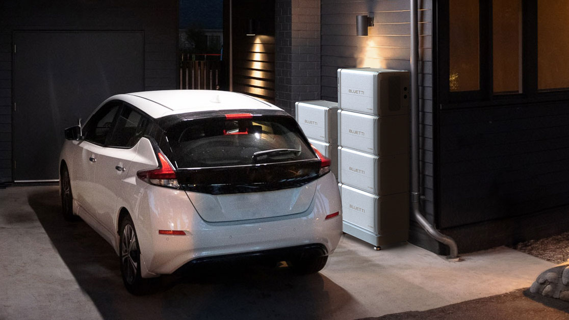 A car in a garage next to a sleek Bluetti EP600 power station stack