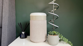Blueair Mini Restful sunrise alarm clock and air purifier positioned on a bedside table next to home d&eacute;cor