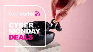 Person picking up Edifier LolliClip earbud from charging case with the words 'TechRadar: Cyber Monday deals'