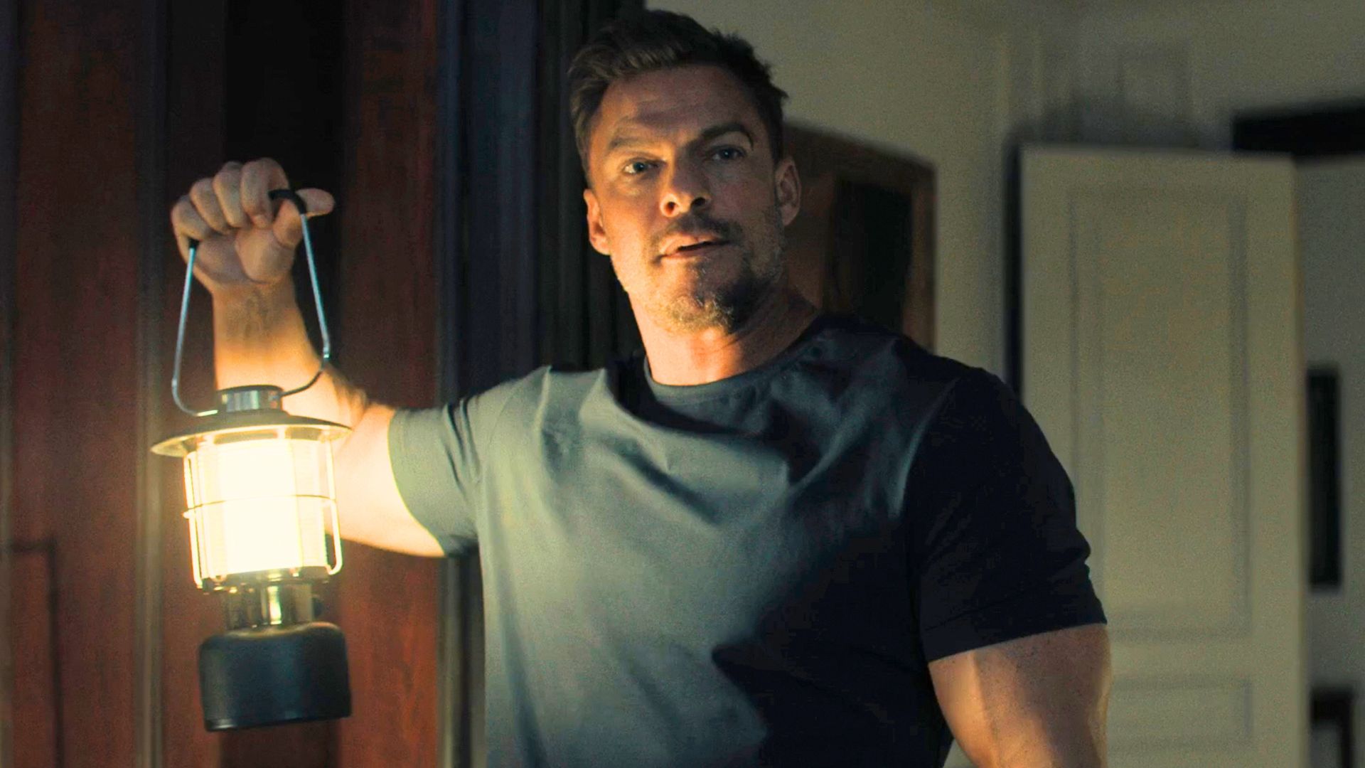 Reacher holds a lantern