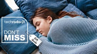 A girl sleeps wrapped up in a blue knitted blanket, to the left is a don't miss logo