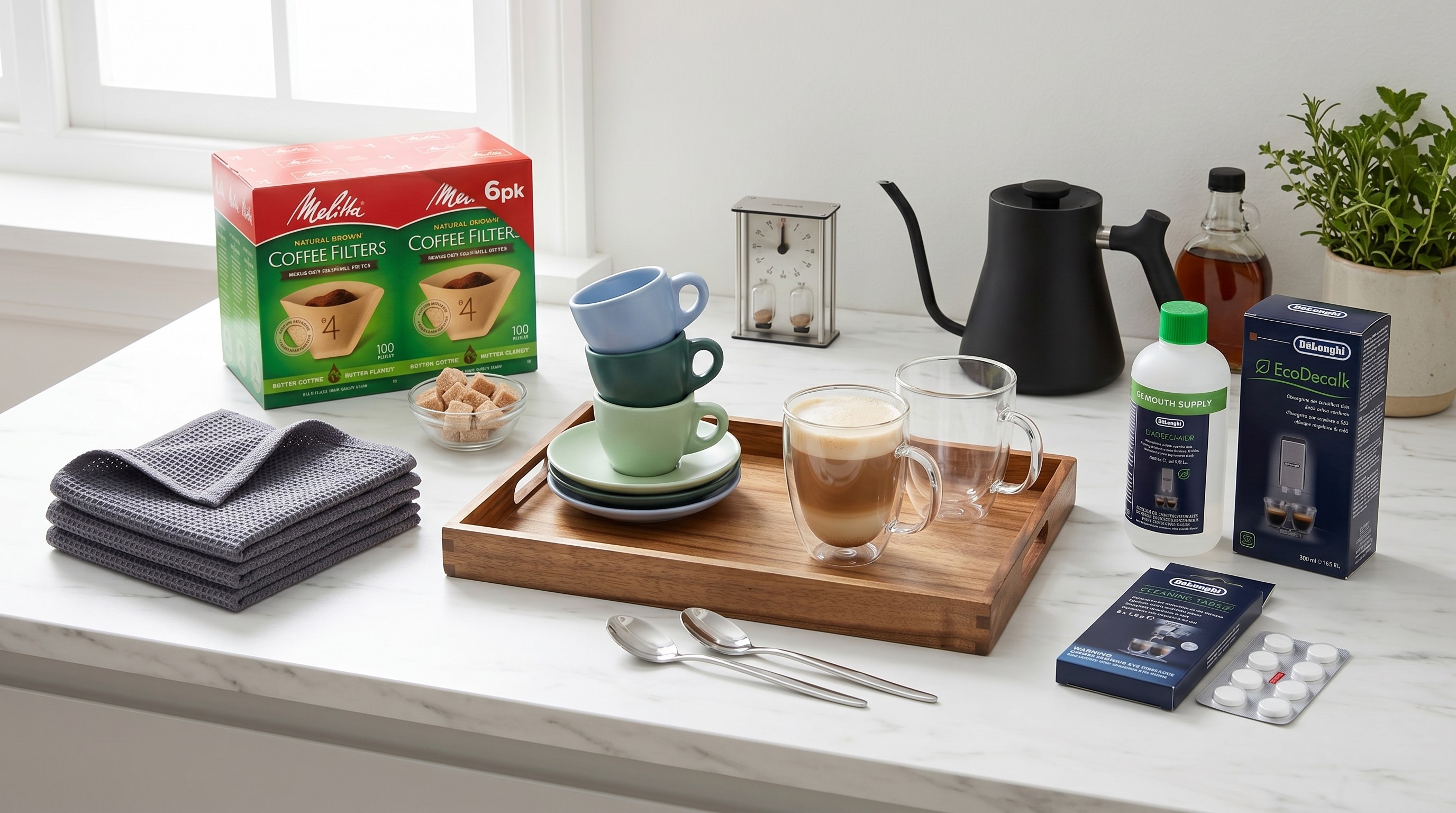 Collection of coffee-making accessories spread out on a marble countertop