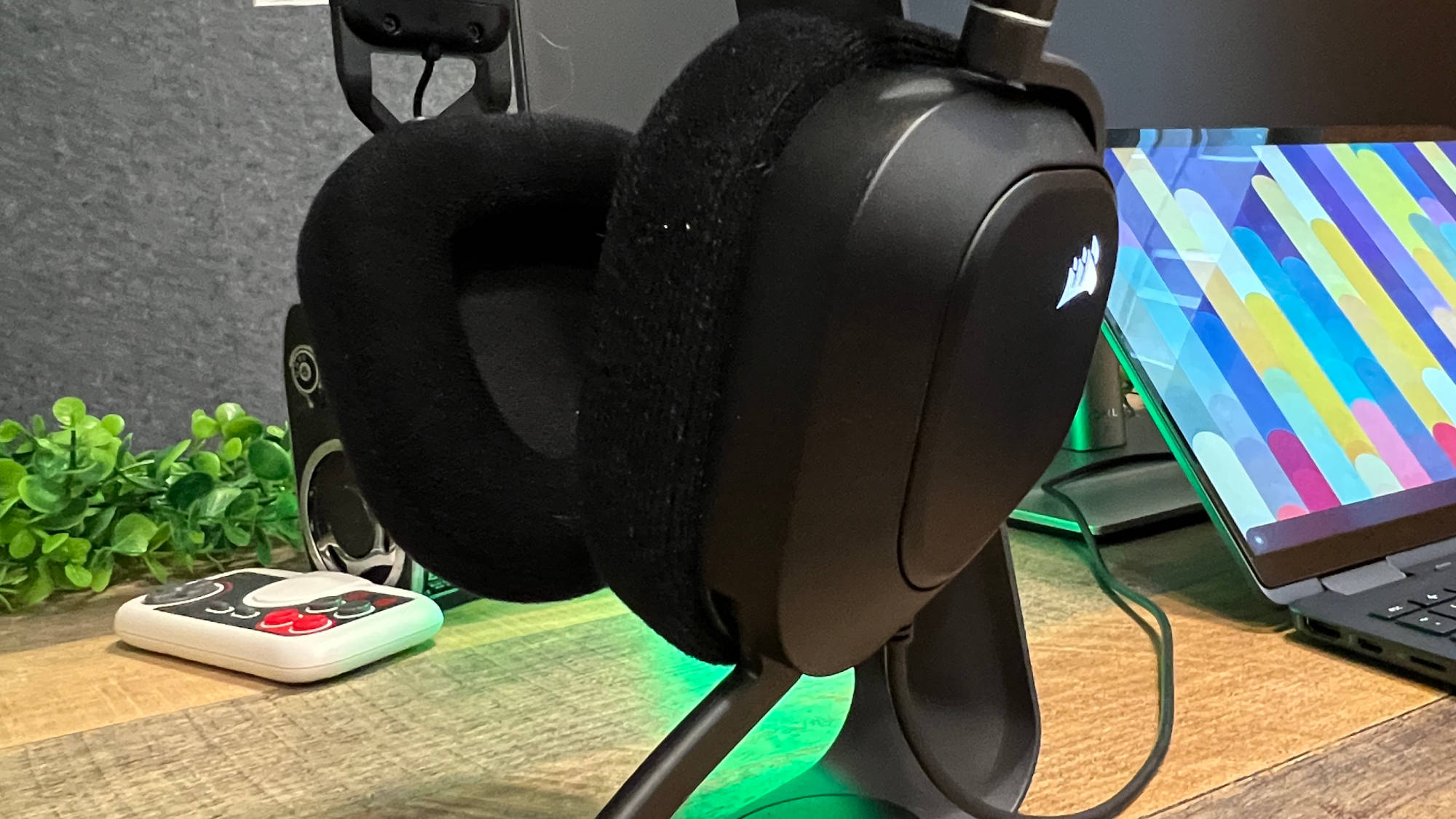 A Corsair HS80 USB on a headset holder on a desk