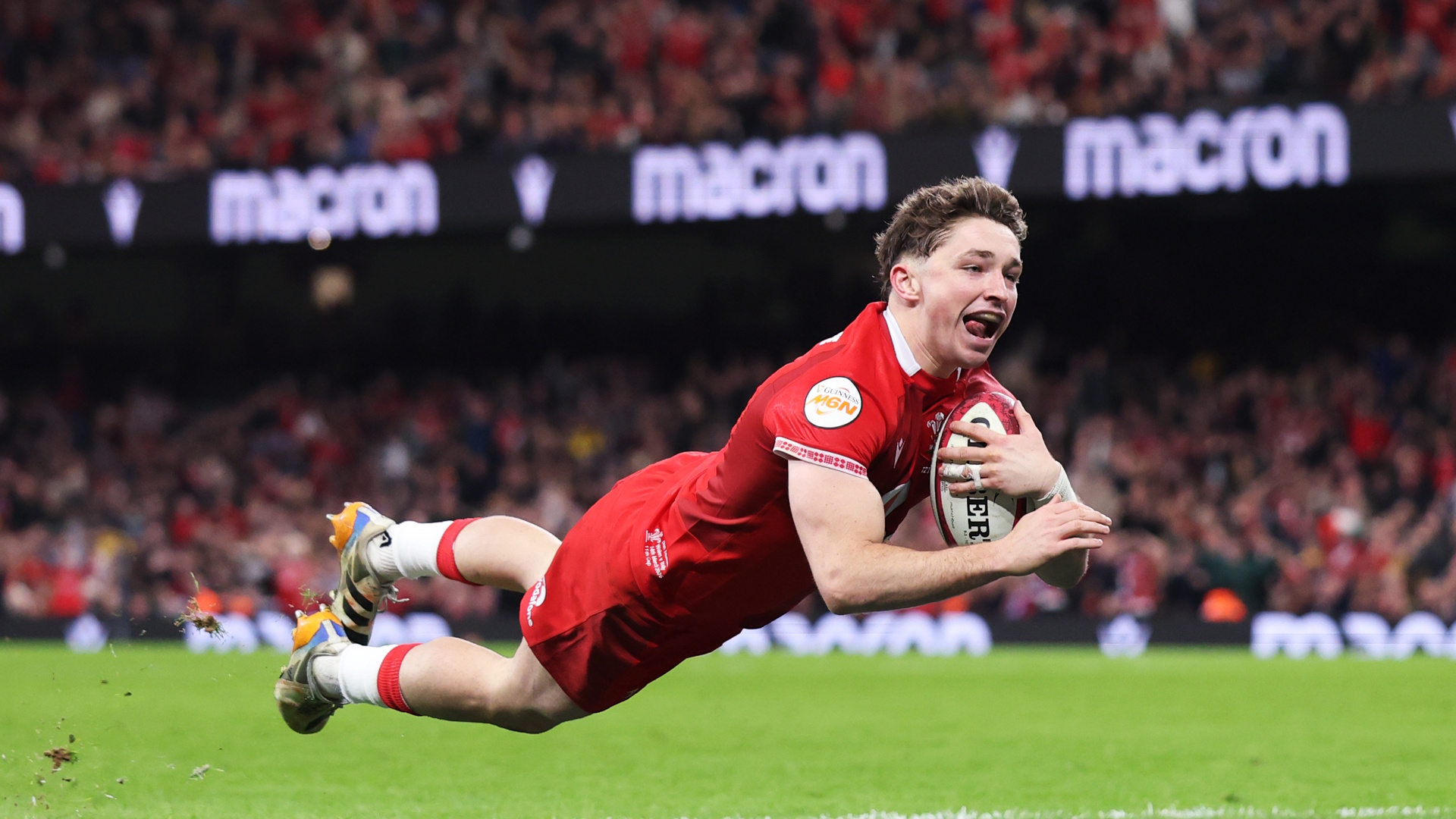 Rugby player Dan Edwards of Wales dives in to score a try.