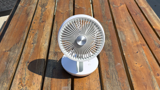 Photo of the Dimplex Rechargeable Cordless Desk Fan on a wooden bench table