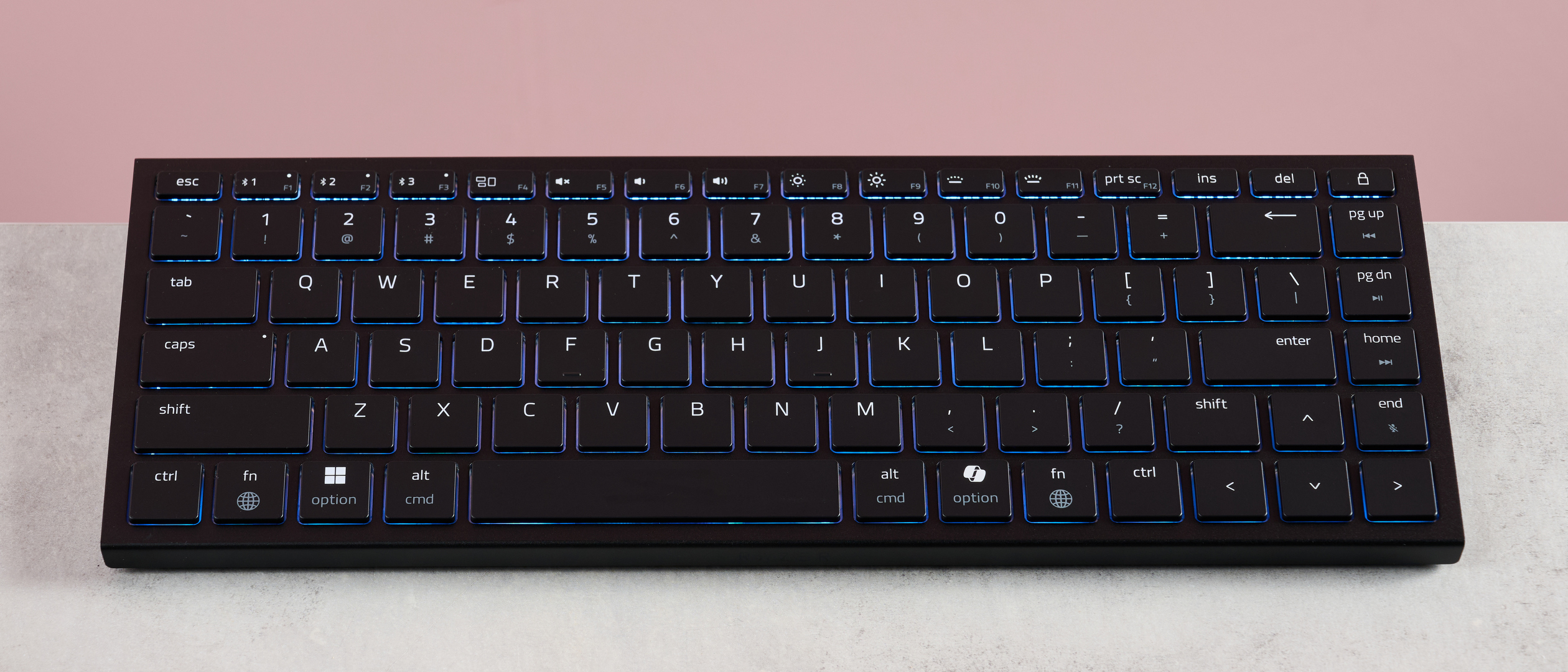 Razer Joro on desk with pink background