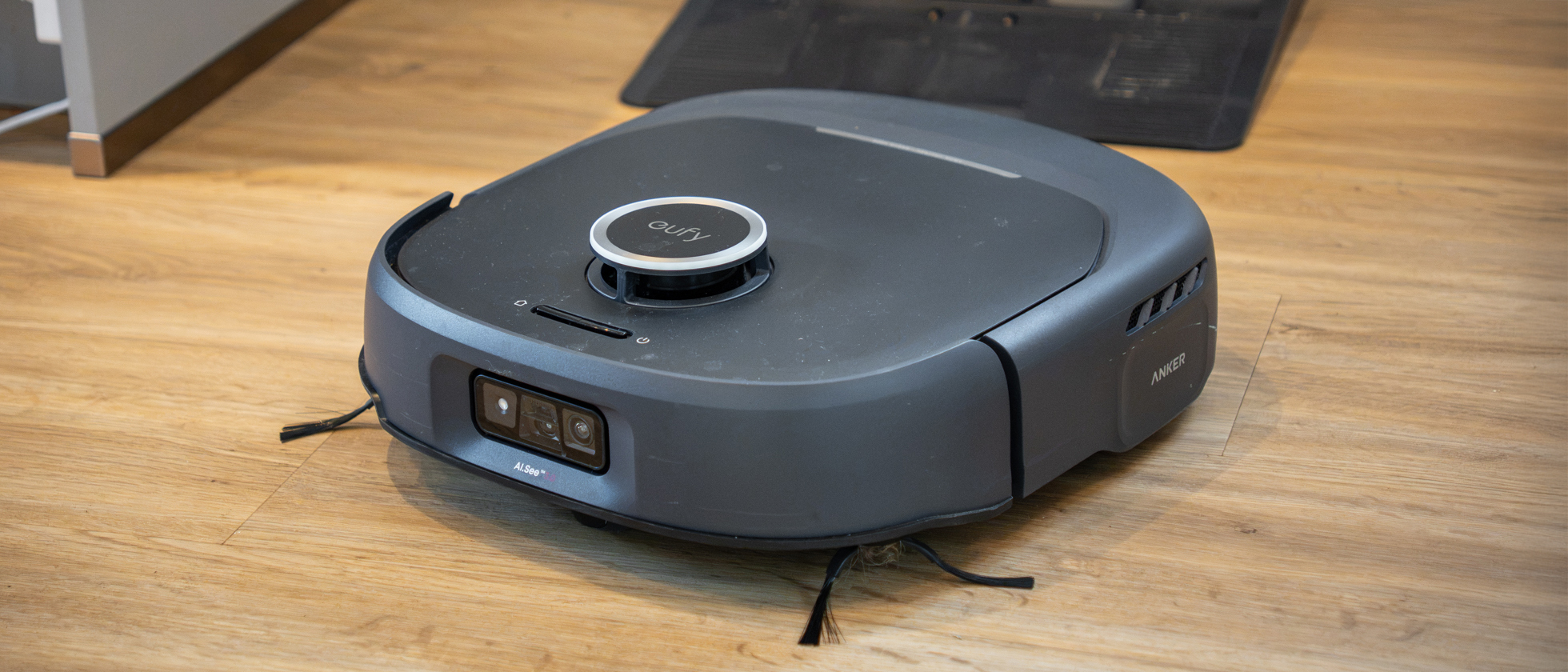 Eufy Omni E35 vacuum cleaner emerging from dock