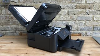 A printer opened up to show its innards