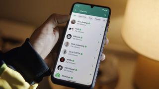 A phone displaying the channels screen on WhatsApp