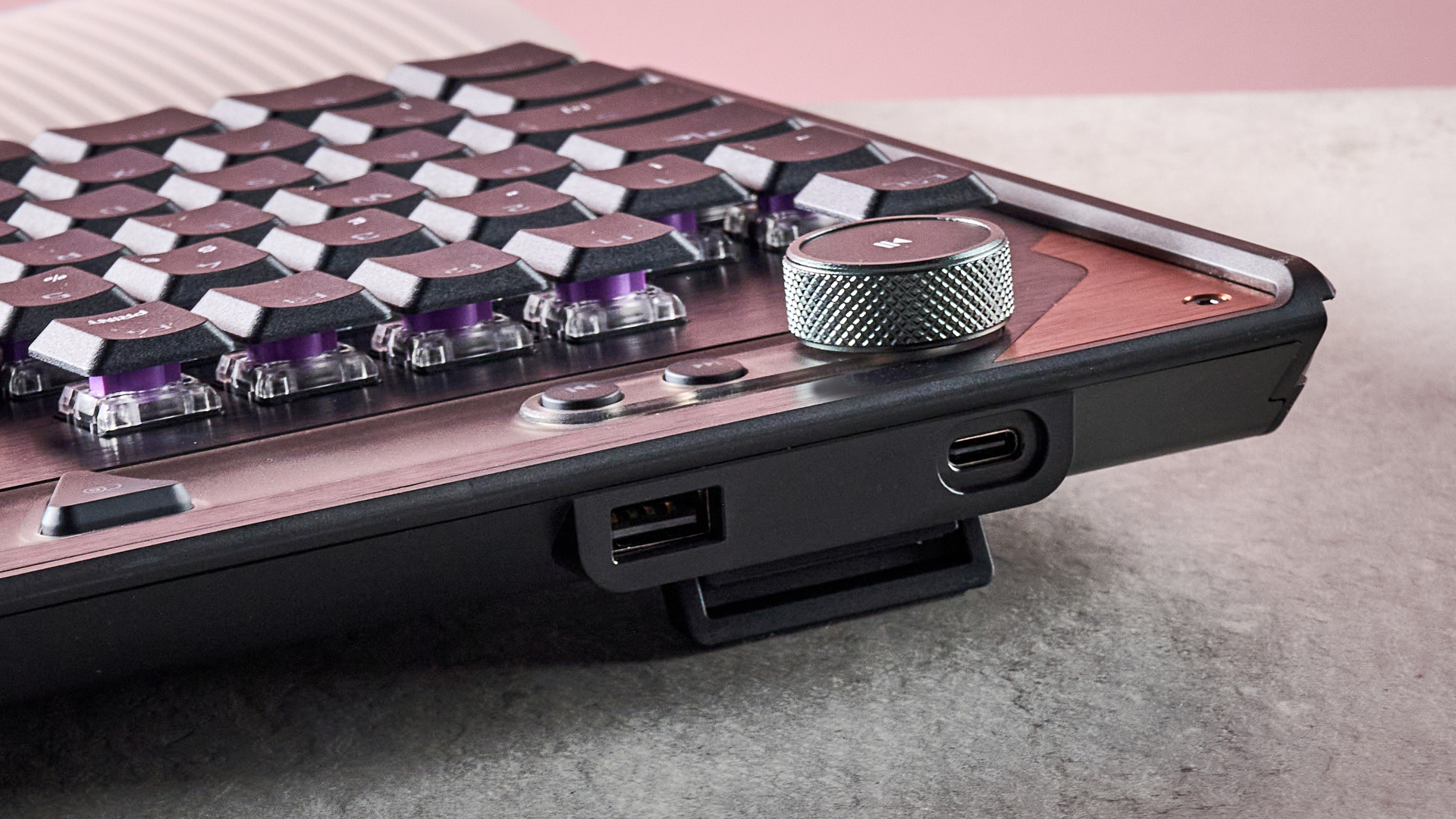 A closeup of the rear corner of the Turtle Beach Command Series KB7, showing its volume knob, media buttons and USB ports.