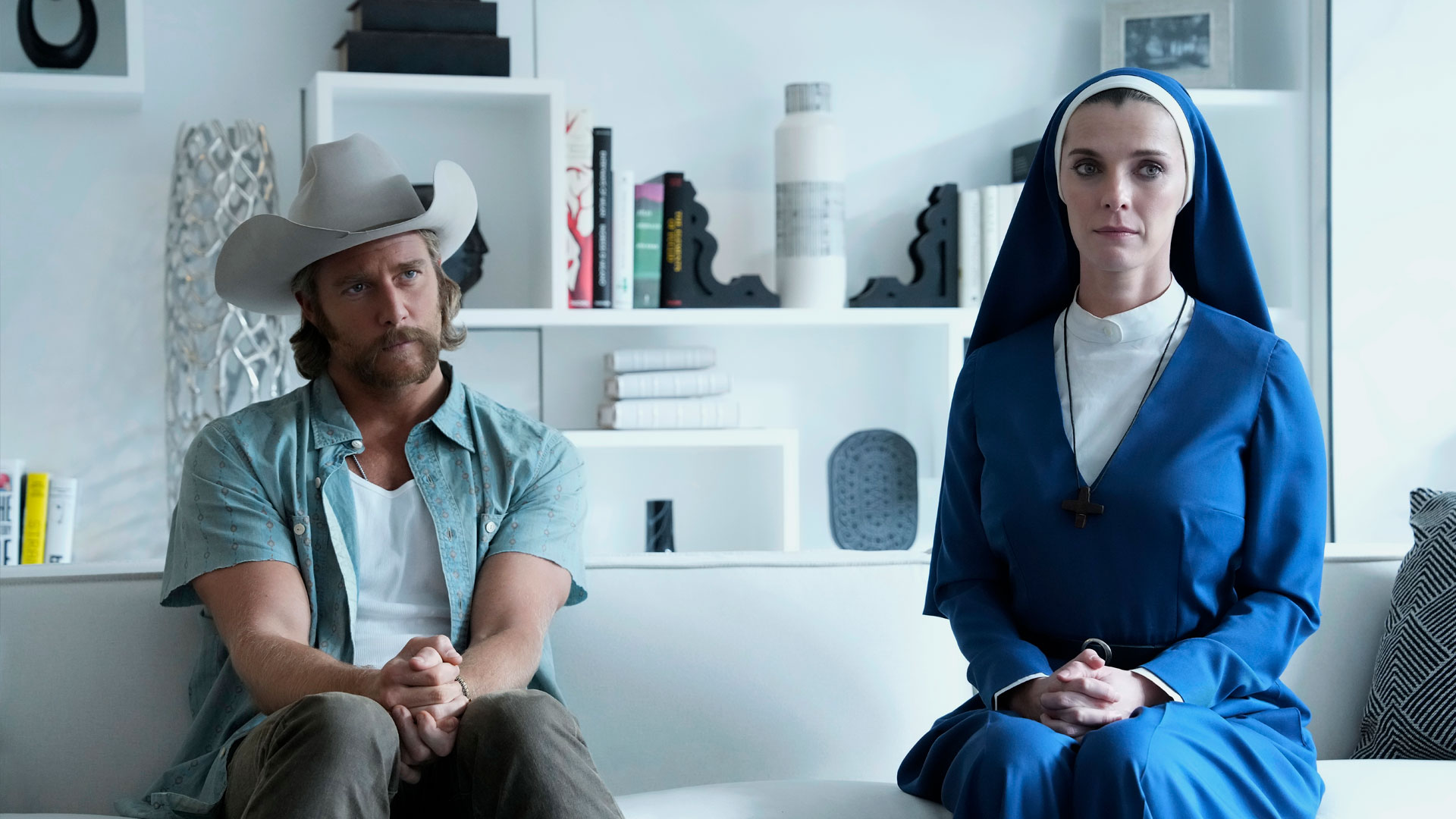Wiley and Mrs Davis sit in a white room