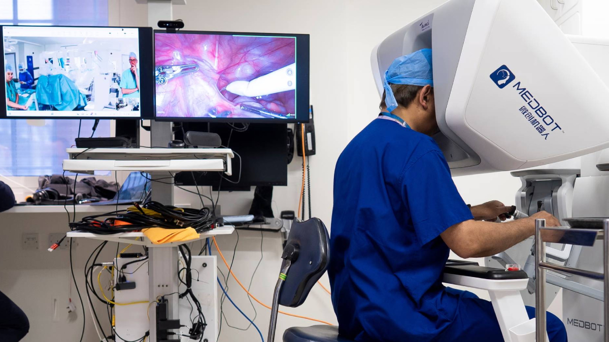 A surgeon looks through a MedBot teleoperation unit