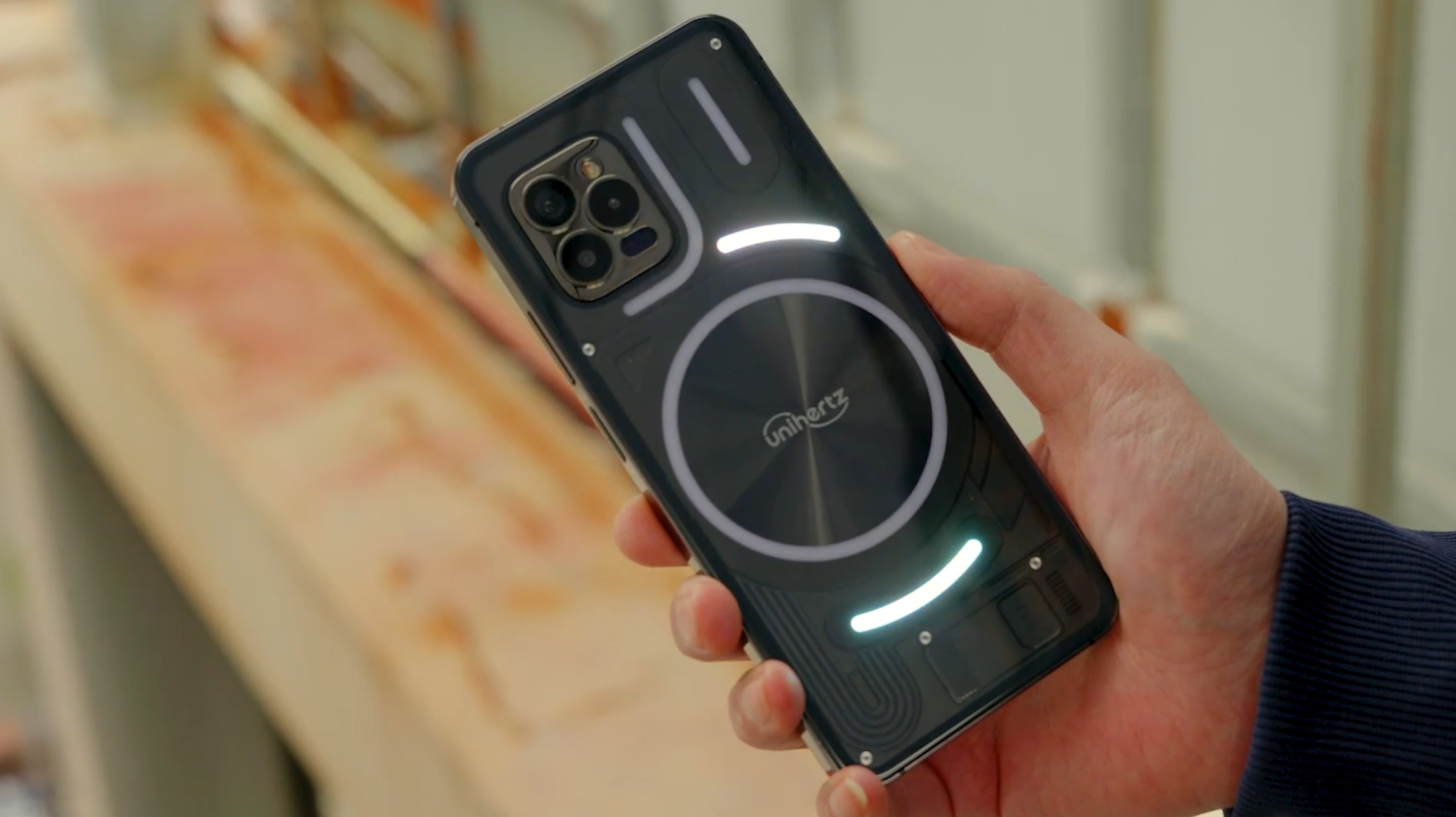 A Unihertz Luna from the back, in someone's hand