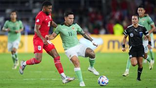 Carmelo Algara&ntilde;az of Bolivia shields the ball from Carlos Harvey of Panama in a Copa America 2024 match