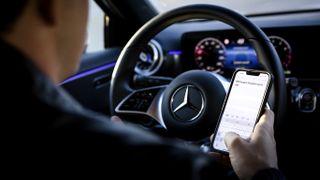 A man on his phone in a car