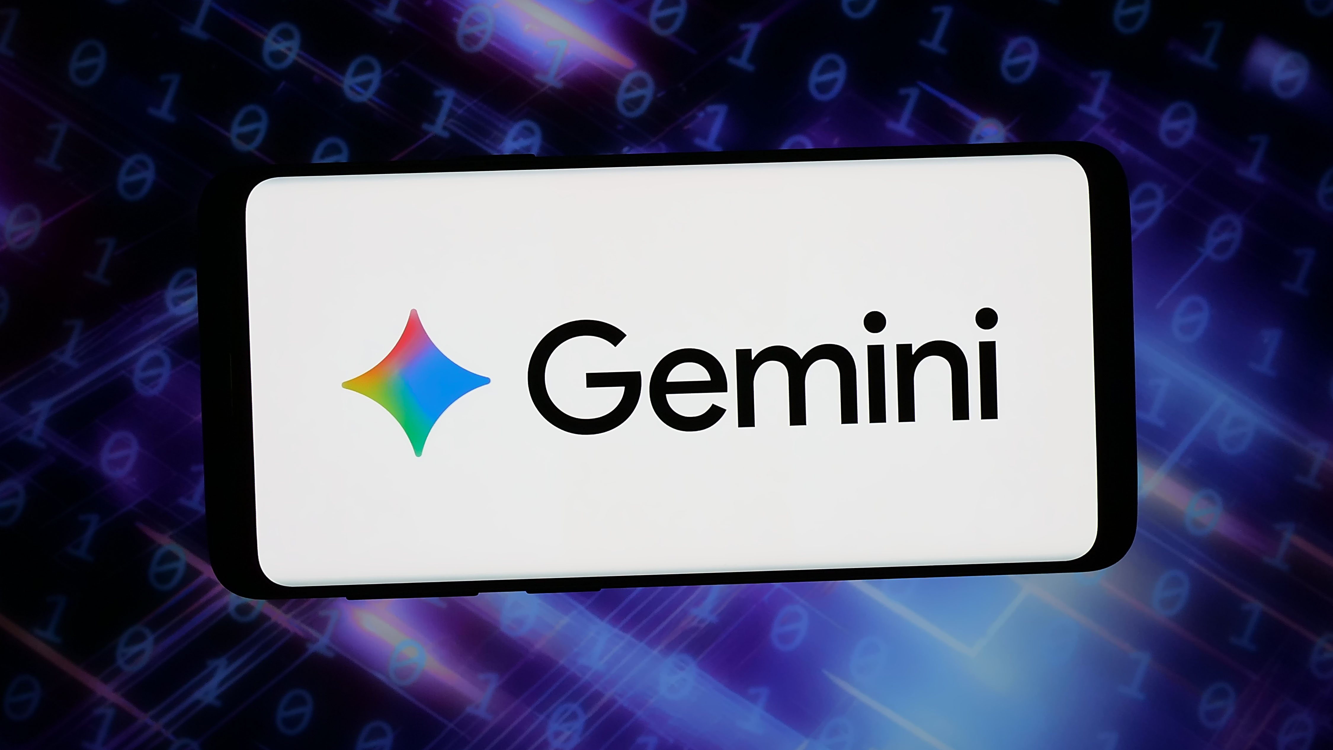 The logo of AI chatbot Google Gemini is seen displayed on a smartphone in front of an abstract background on computer screen. 